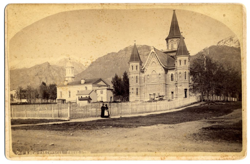 This historic image features both the "Old" and "New" Provo Tabernacles in Provo, Utah, circa 1885